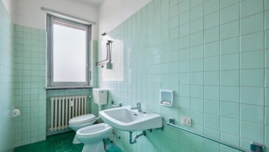 Old bathroom interior with green tiles