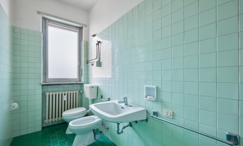 Old bathroom interior with green tiles